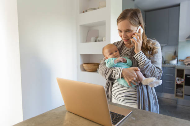 istock Focused new mom holding baby 1200791337