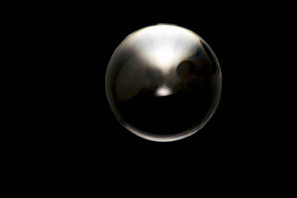 istock clear crystal ball on black abstract dark and light 1200794141