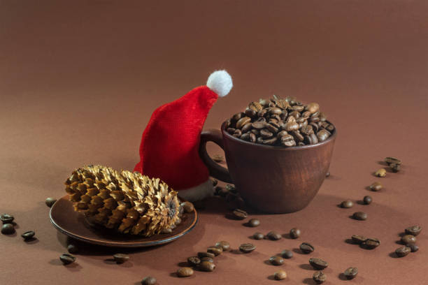 istock Coffee beans on a Christmas brown table. 1200796398