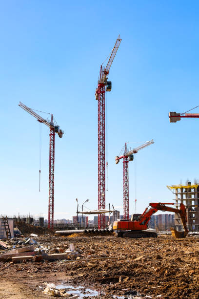 istock Construction of multi-storey buildings near Moscow. Construction cranes on the construction site. Sunny day. 1200796844