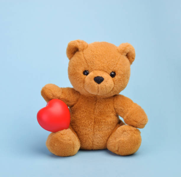 Teddy bear with heart love concept Teddy bear with heart love concept behavior teddy bear doll old stock pictures, royalty-free photos & images