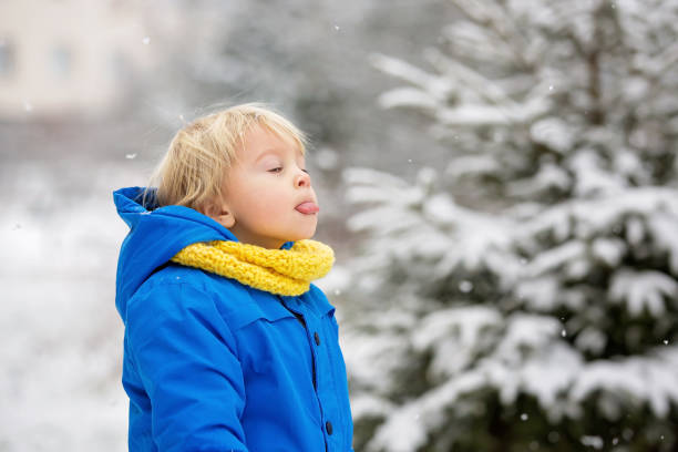 istock Sweet toddler boy, playing with snow on playground 1200798078