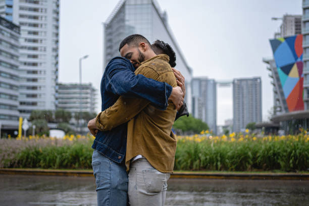 istock Affectionate homosexual couple embracing each other outdoors while it rains 1200798302