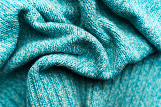 istock Crumpled texture of a blue turquoise knitted fabric 1200799018