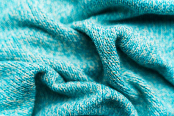 istock Crumpled texture of a blue turquoise knitted fabric 1200799097