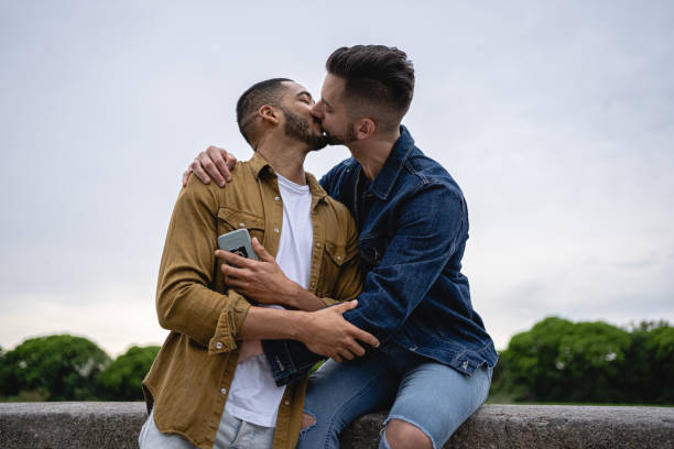 istock Two handsome dating men kissing at a park 1200799213
