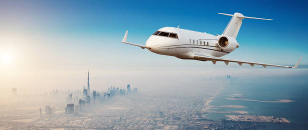 istock Private jet plane flying above Dubai city 1200799427