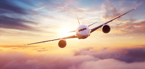 istock Commercial airplane flying over dramatic sunset 1200799502