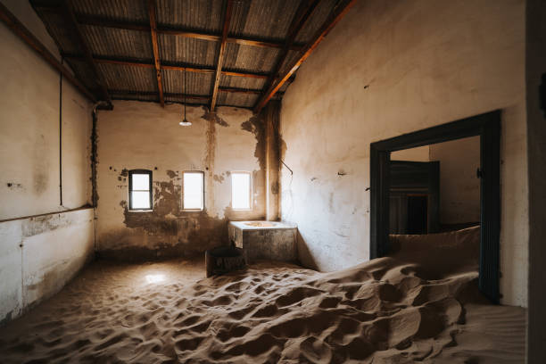 istock Old abandoned industrial building slowly filled with sand 1200802259