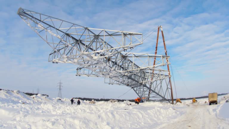 workers install high voltage line support pulling by mechanisms