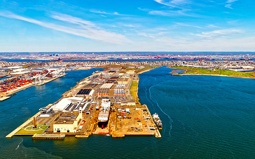 Aerial view of Dry Dock and Repair and Port Newark and Global international shipping containers, Bayonne, New Jersey. NJ, USA. Harbor cargo. Staten Island with St George Ferry terminal, New York City
