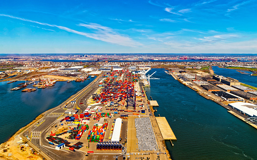 Aerial view of Dry Dock and Repair and Port Newark and Global international shipping containers, Bayonne, New Jersey. NJ, USA. Harbor cargo. Staten Island with St George Ferry terminal, New York City