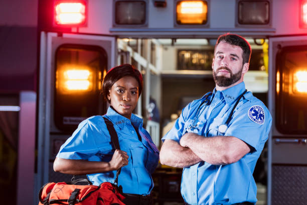 istock Two multi-ethnic paramedic with ambulance 1200805124