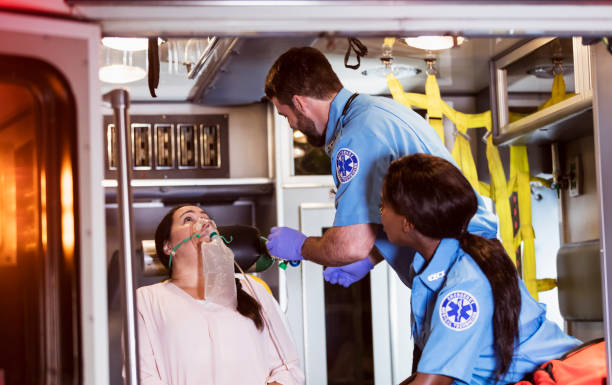 istock Paramedics helping woman in ambulance 1200805199