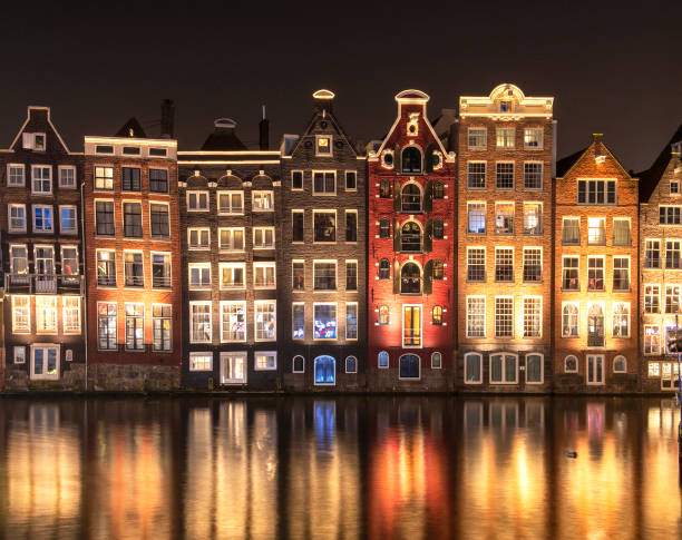 istock Typical Amsterdam houses with reflection in the water 1200805261