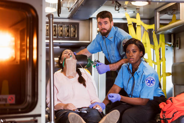 istock Paramedics helping woman in ambulance 1200805883