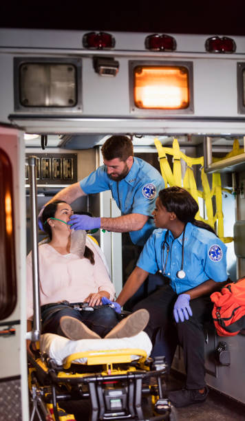 istock Paramedics helping woman in ambulance 1200805995