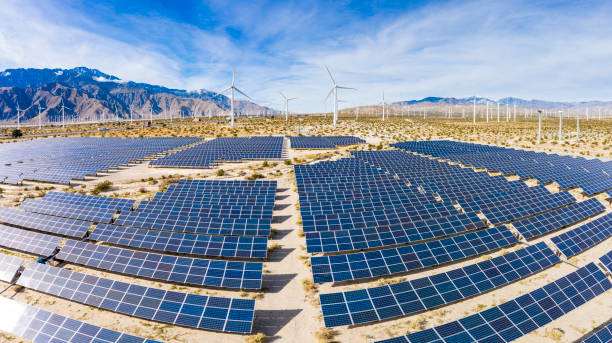 Aerial View over Solar Panels and Windmills