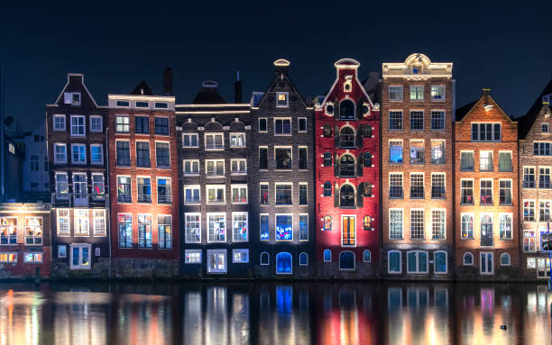 istock Typical Amsterdam houses with reflection in the water 1200806093