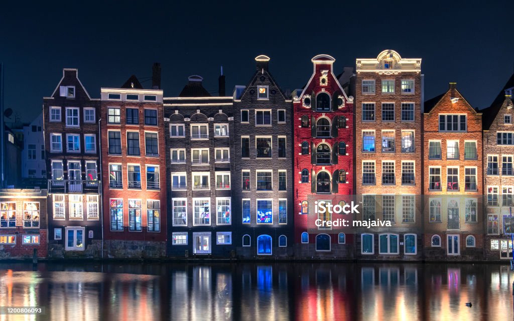 Typical Amsterdam houses with reflection in the water Amsterdam Stock Photo