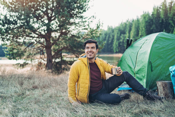 istock Tourist resting by his tent in a mountain camp 1200807314