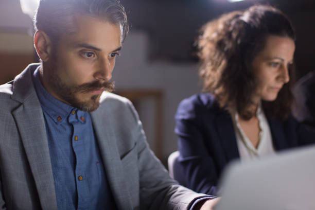 istock Concentrated handsome businessman looking at laptop 1200808900