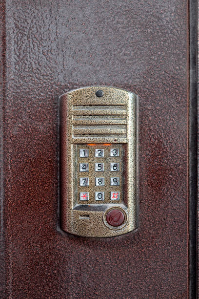 istock an intercom with a microphone and speaker for ringing an apartment with a keypad for dialing and a scanner key chip for access on iron doors, close up nobody. 1200809073