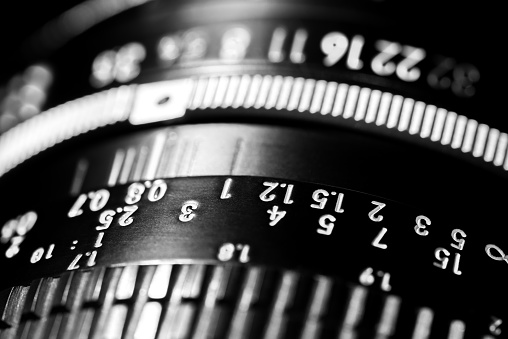 Scale of the photo lens. The black lens is made of metal and plastic. Shallow depth of field.