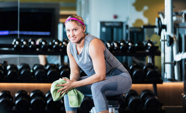 istock Hispanic woman working out at gym, resting 1200812507
