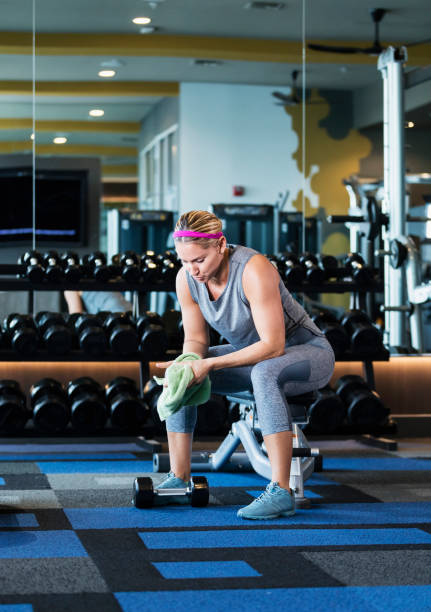 istock Hispanic woman working out at gym, resting 1200813086