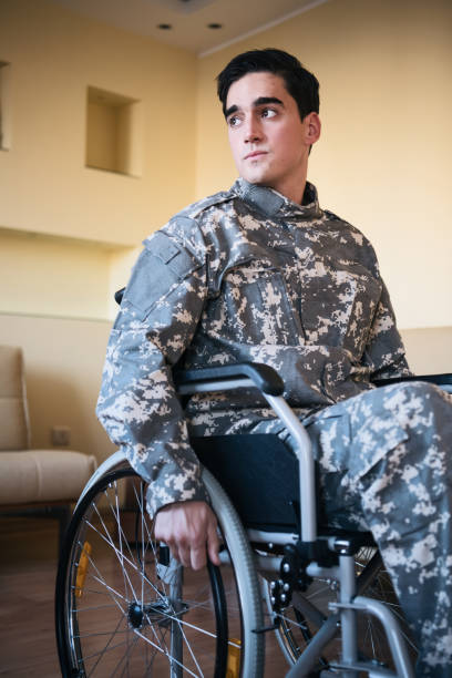 istock Retired War Veteran in Wheelchair Looking Through the Window 1200815764
