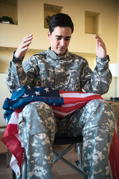 istock Retired Soldier with US Flag Feeling Sad and Lonely 1200816294