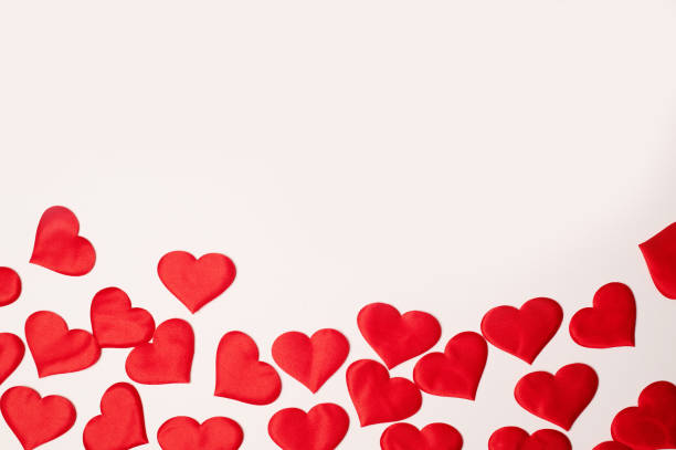 istock Valentine's Day. Many red hearts on a white background.Texture. Free space on top 1200817359