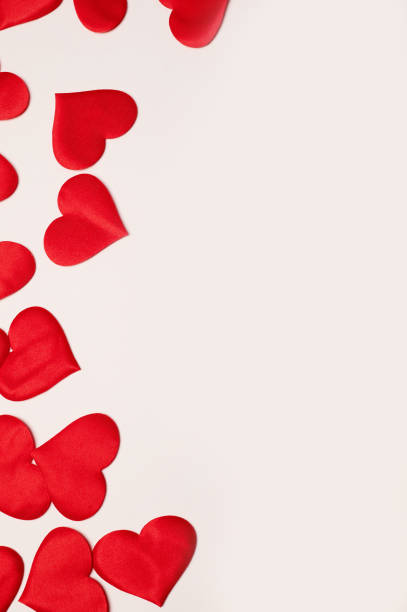 istock Valentine's Day. Many red hearts on a white background.Texture. Free space on the right 1200817366
