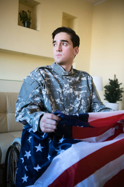 istock Disabled War Veteran with US Flag Feeling Sad and Lonely 1200817755