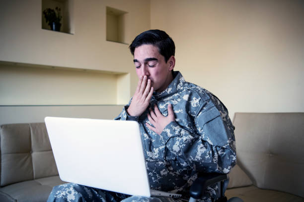 istock Retired Soldier With Physical Disabilities is Using a Laptop and Feeling Sadness 1200817863