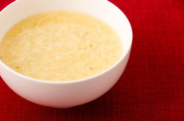 istock Sweet corn egg drop soup in white bowl on red cloth 1200817865