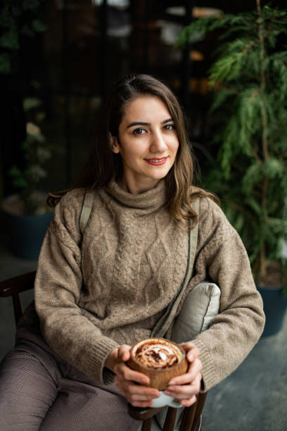 istock Brunette Woman Drinking Coffee in Cafe 1200818728