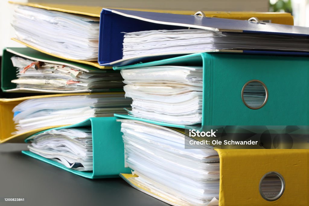 Pile of different file folders or ring binders full with office documents and paper work Ring Binder Stock Photo