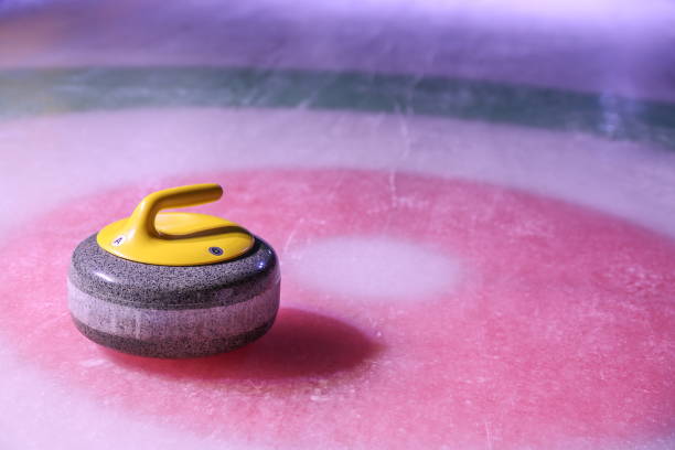 istock curling stone on ice near the house background with copy space 1200827643