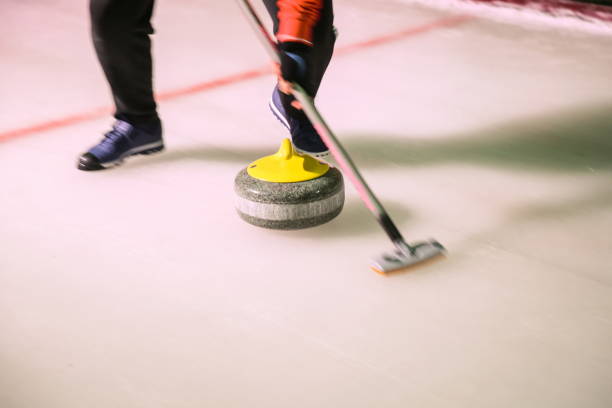 istock curling stone on the ice in motion close up 1200827645