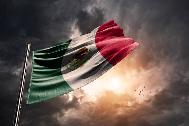 Mexico flag and a dramatic sunset Mexican flag and a sunset with dramatic storm clouds. tropical storm photos stock pictures, royalty-free photos & images