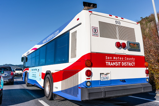 Dec 28, 2019 San Mateo / CA / USA - SamTrans bus driving in heavy traffic; SamTrans is a public transport agency in and around San Mateo county, San Francisco Bay Area, California