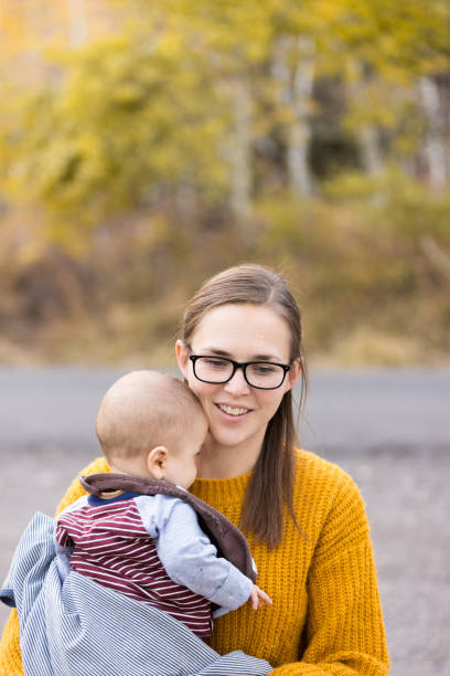 istock Mother holding young son outdoors 1200828814