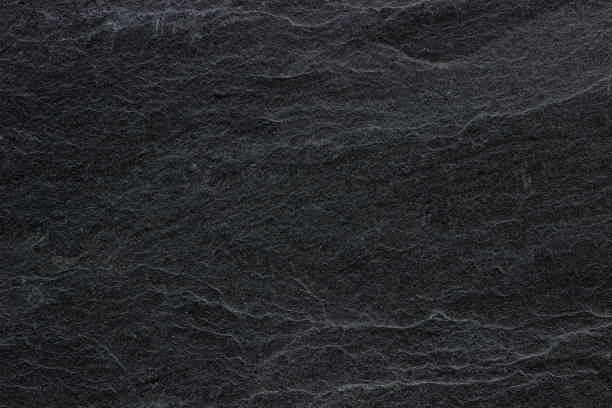 istock Dark grey black slate background or texture. black stone 1200830589