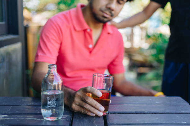 istock Alcohol addicted man sleeping at the table , Hangover depressed man after hard drinking 1200834132