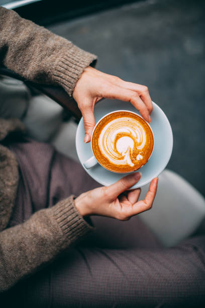 istock Flat Lay Woman Hand Holding Coffee Latte 1200836996