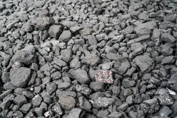 istock Char-coal. Pattern, heap. Pile of Bituminous Coal cinder. Stone coal Industry, business. Black coal mine close-up with soft focus. Anthracite coal bar 1200837624