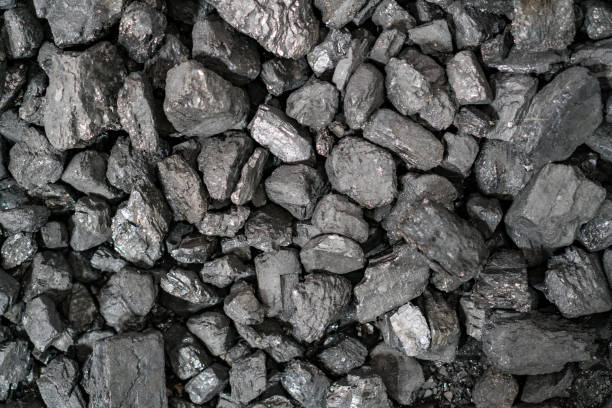 istock Char-coal. Pattern, heap. Pile of Bituminous Coal cinder. Stone coal Industry, business. Black coal mine close-up with soft focus. Anthracite coal bar 1200837676