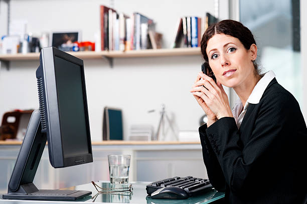 Businesswoman on phone looking at the camera stock photo
